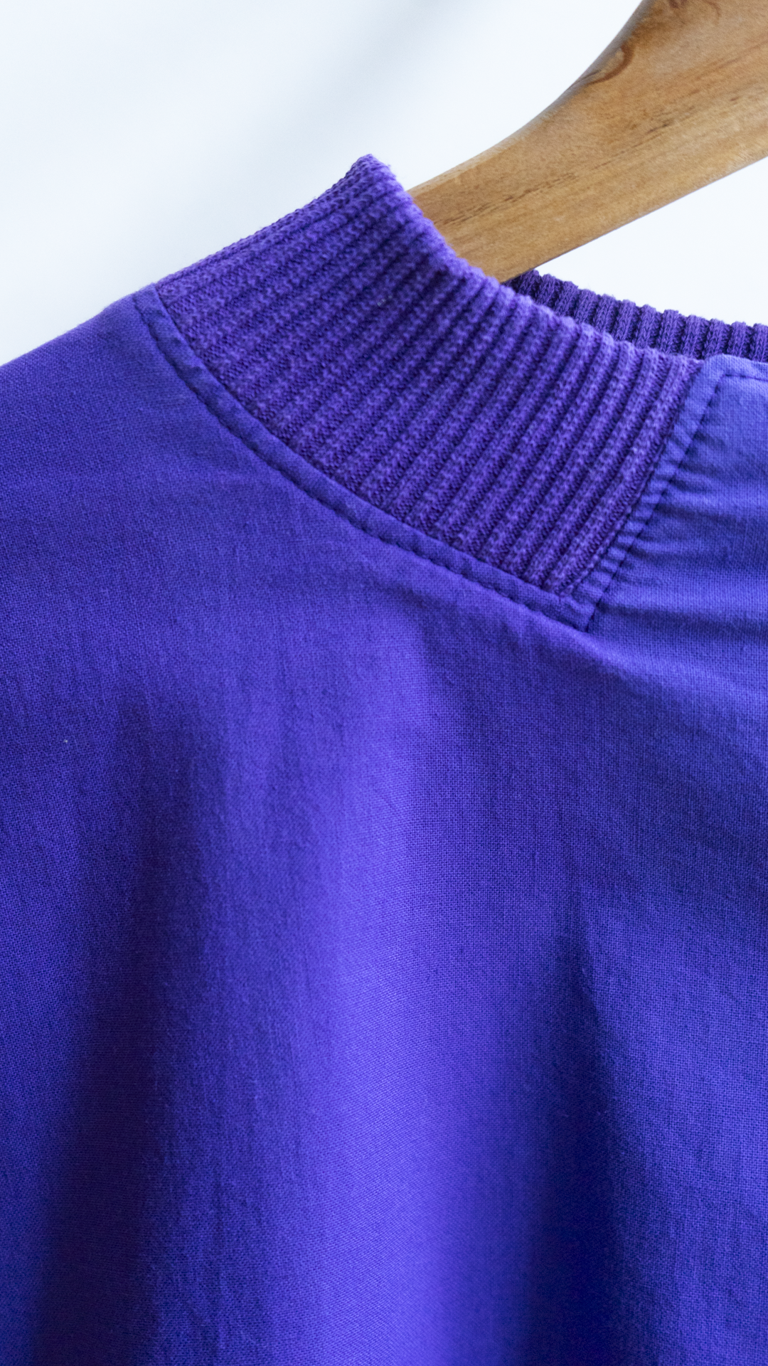 detail of a ribbed collar from a purple 80s pullover
