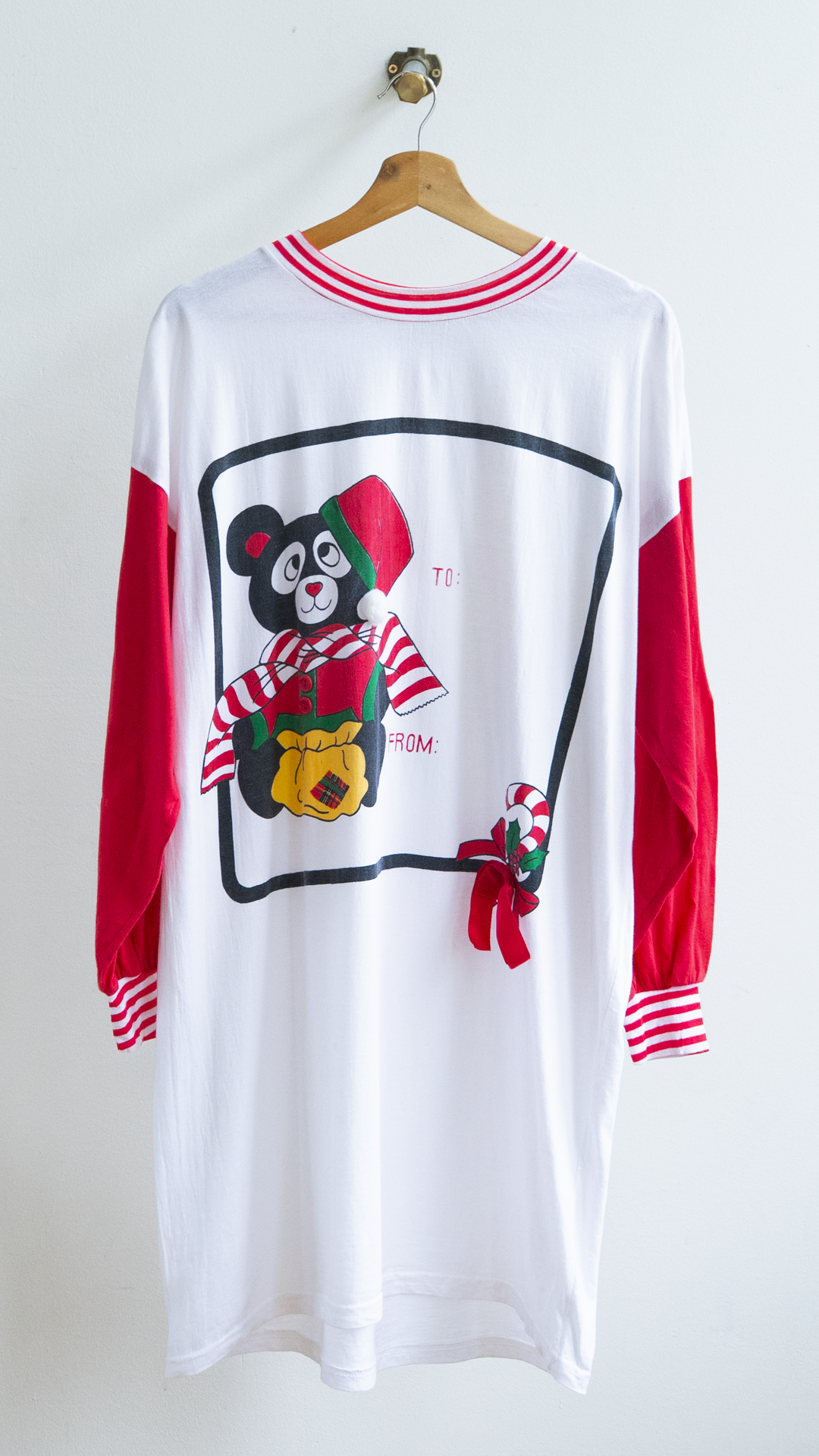 80s christmas oversized onesize nightshirt in white with red sleeves featuring a teddy bear in winter outfit and a candy cane.