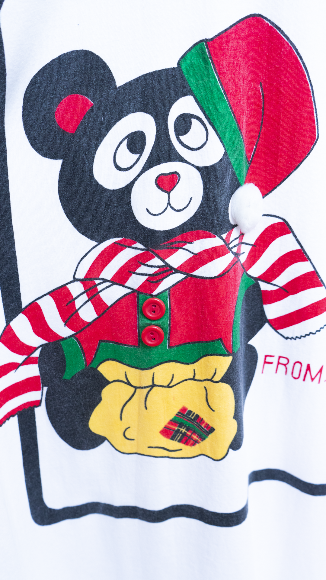 detail of teddy bear in festive outfit on a onesize christmas nightshirt with 3D details with distinct 80s character