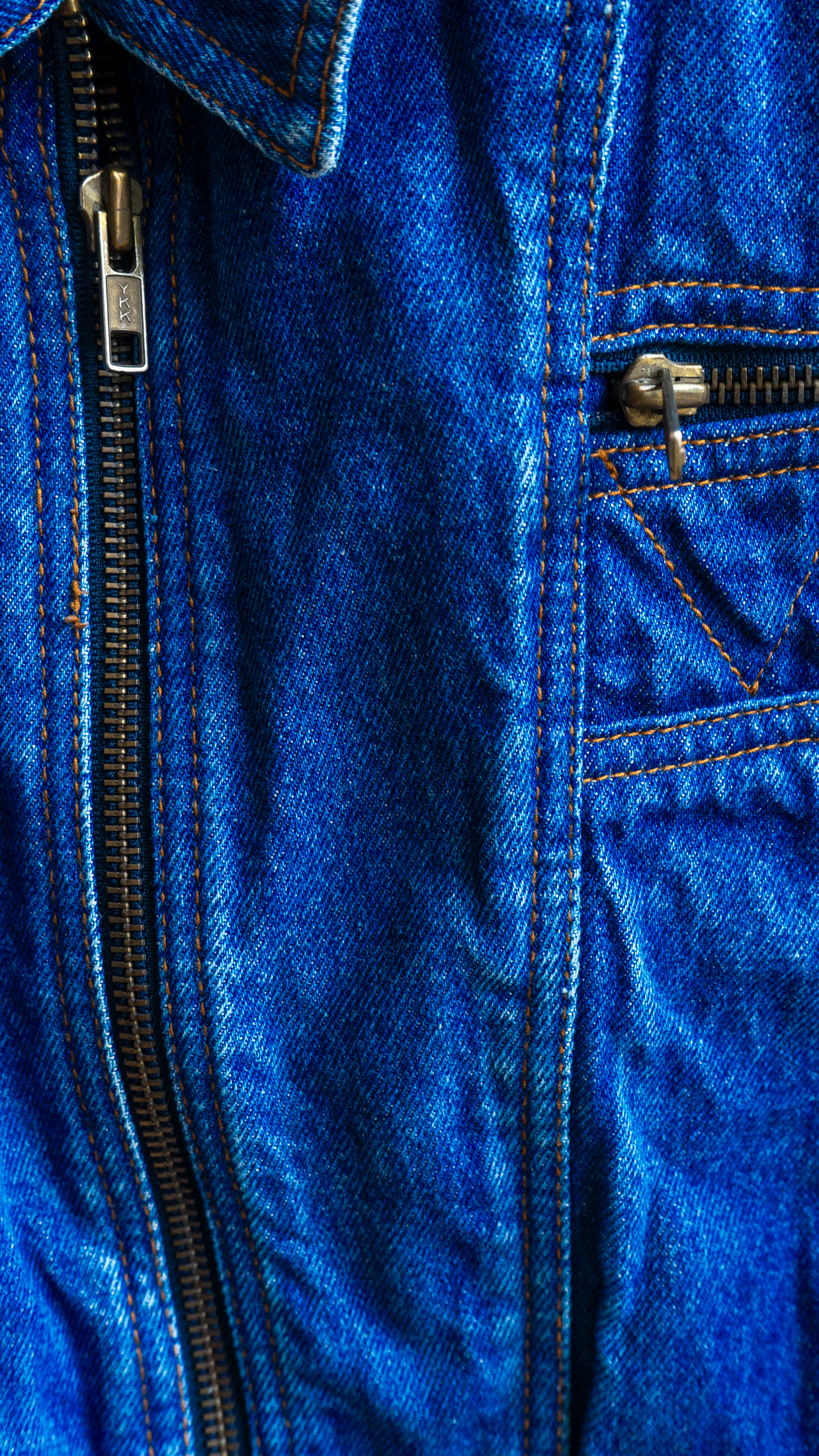 detail of blue vintage denim biker jacket with batwing sleeves and zipper close-up of zipper fresh vintage
