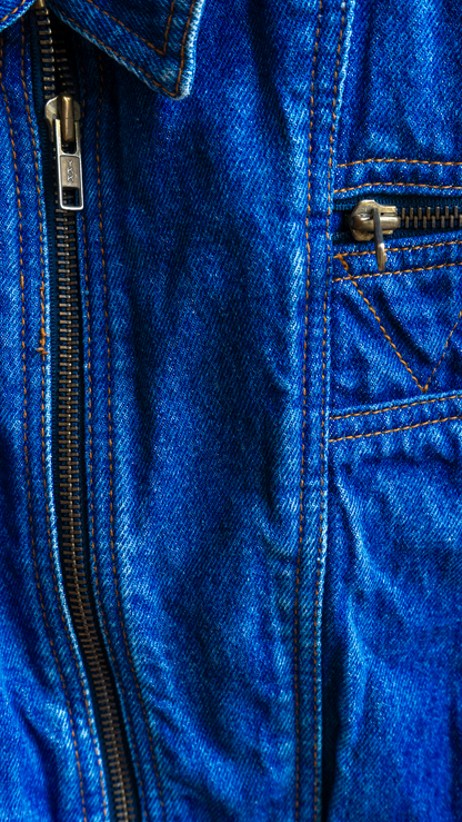 detail of blue vintage denim biker jacket with batwing sleeves and zipper close-up of zipper fresh vintage