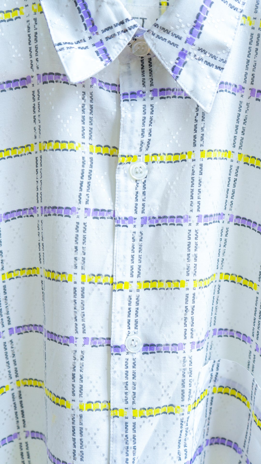 detailed view of white vintage shirt with buttons and squares with purple and yellow lines fresh vintage
