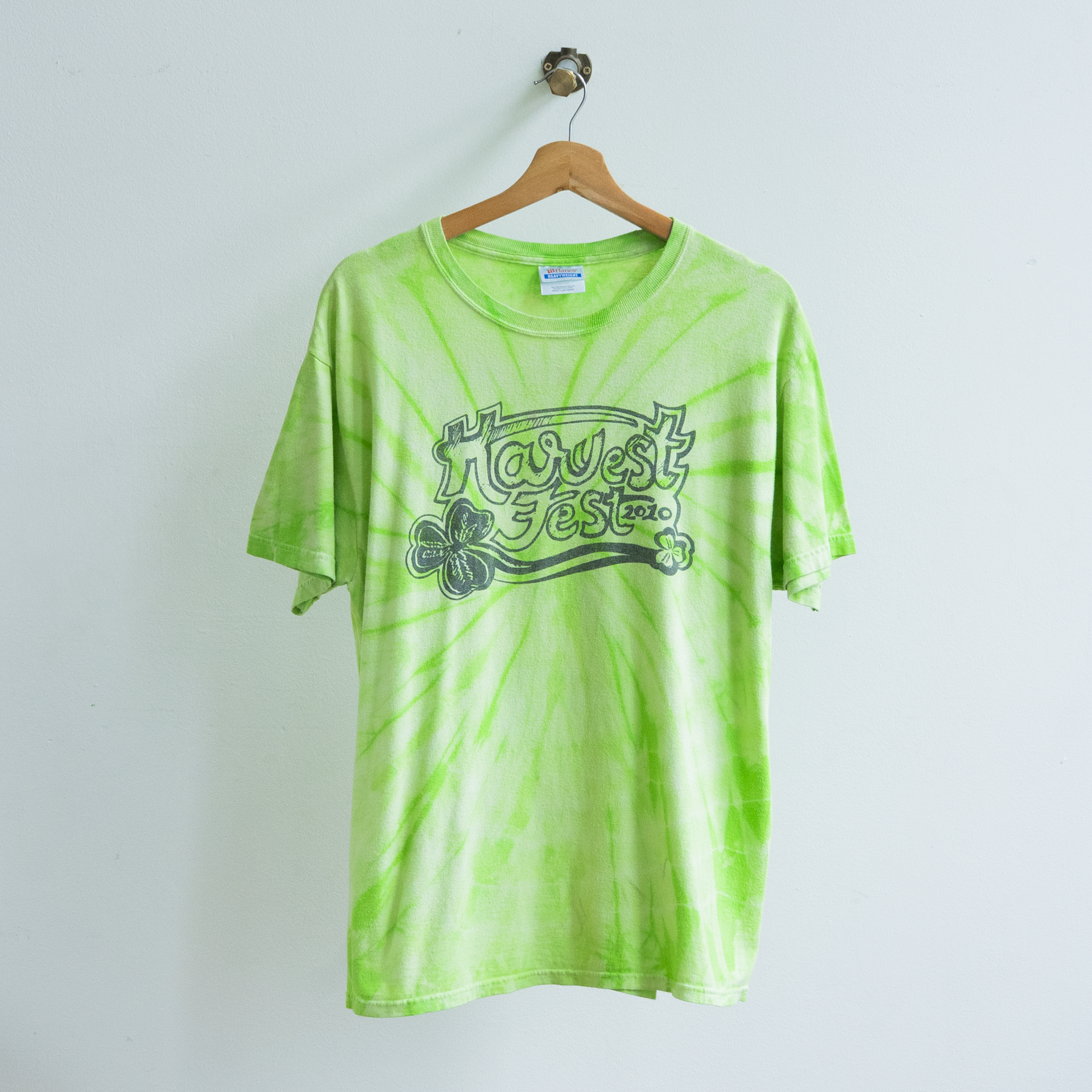 secondhand light green tie-dyed t-shirt with text 'harvest fest'