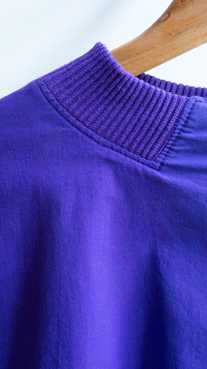detail of a ribbed collar from a purple 80s pullover