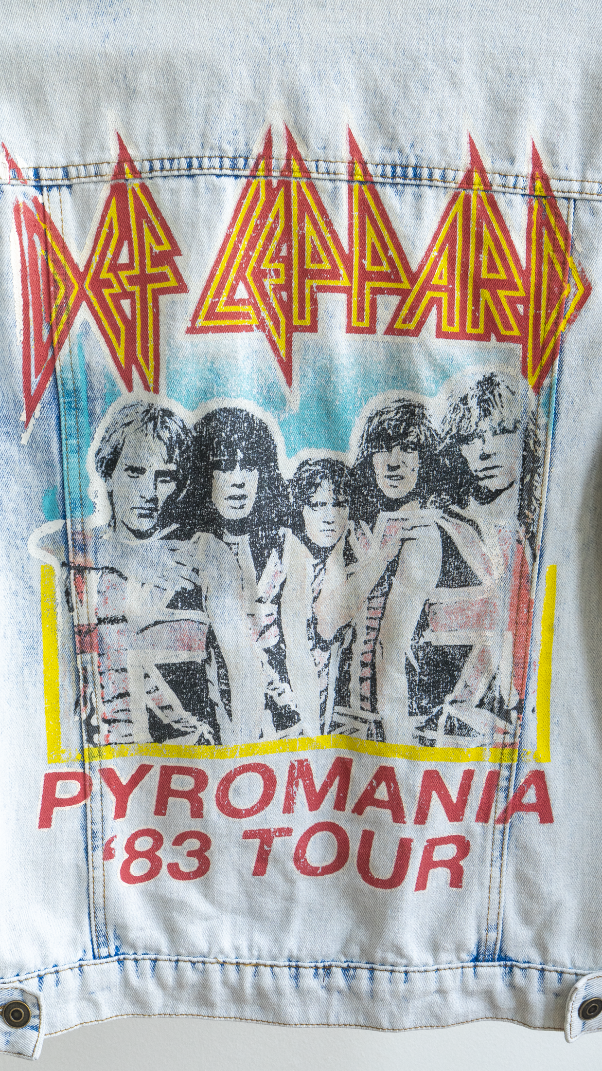 detail of vintage denim jacket of Def Leppard with 'Pyromania '83 Tour' design on the back of the jacket