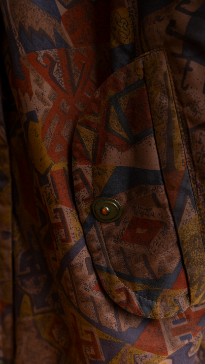 detail of pocket of an eighties patterned brown coat with a metal button Fresh Vintage