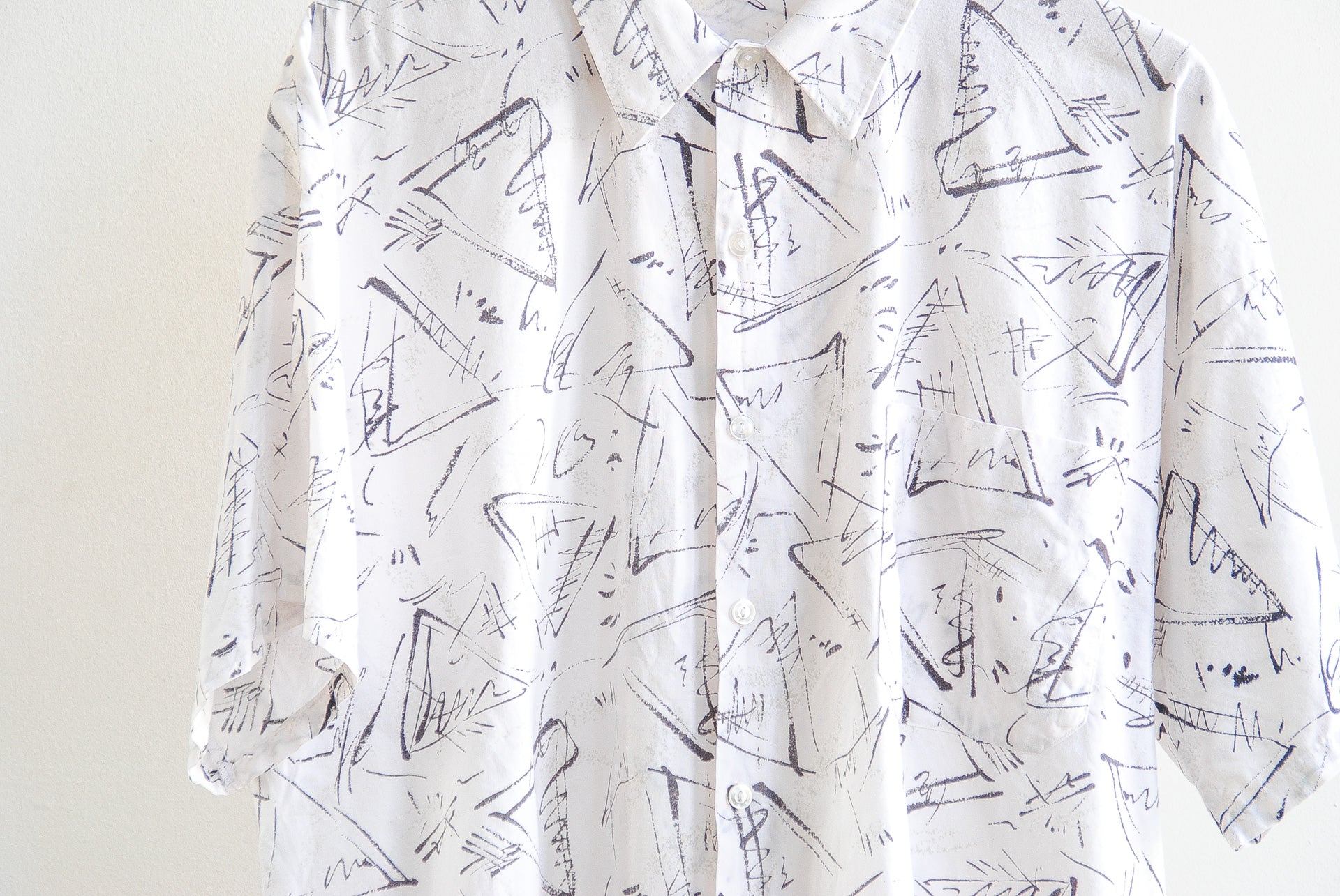 White vintage shirt with black abstract pattern and buttons detail